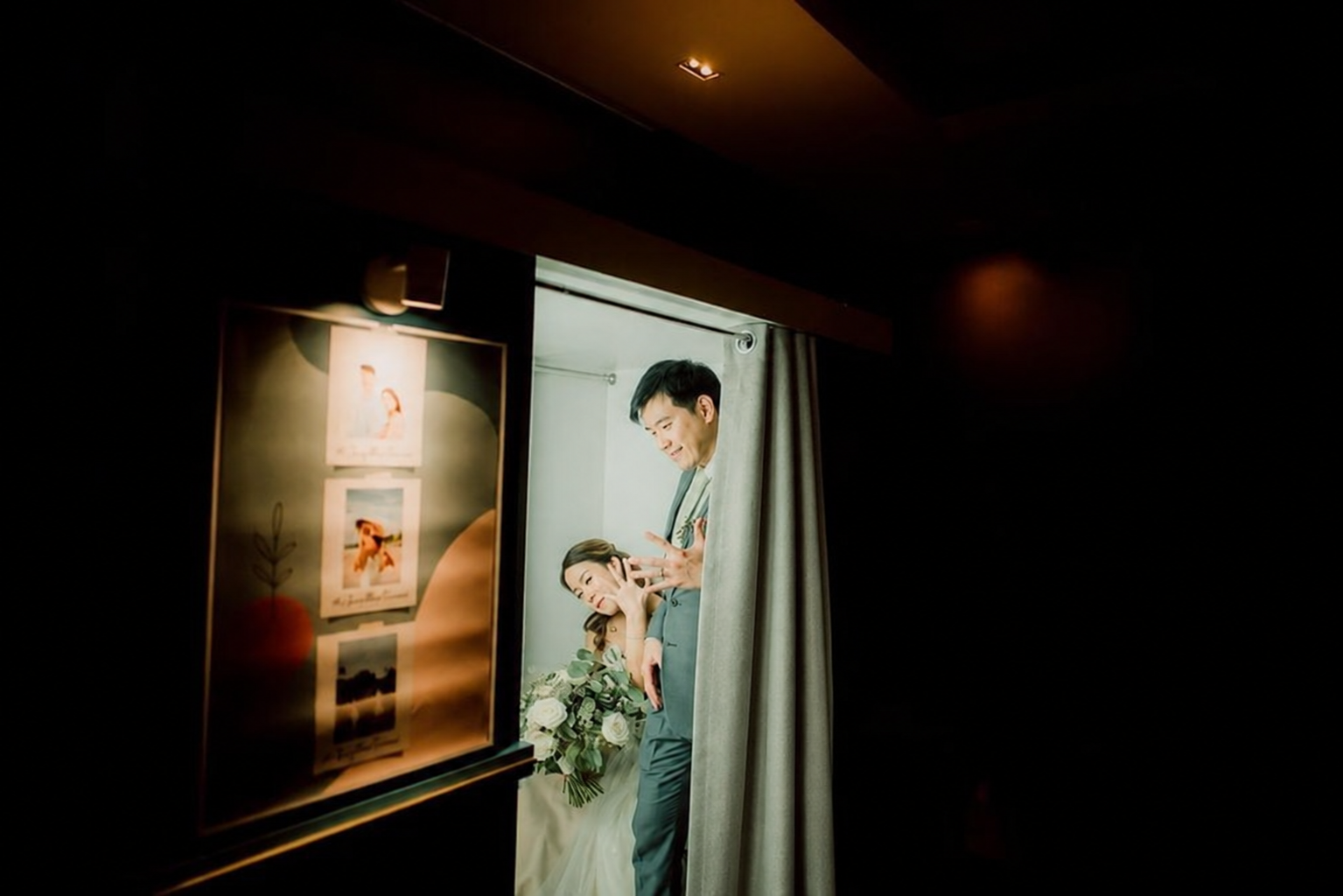 A couple having fun inside the enclosed Flashbox beside a neatly arranged curtain